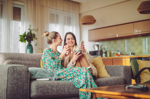 South Florida sisters shopping on phone in living room