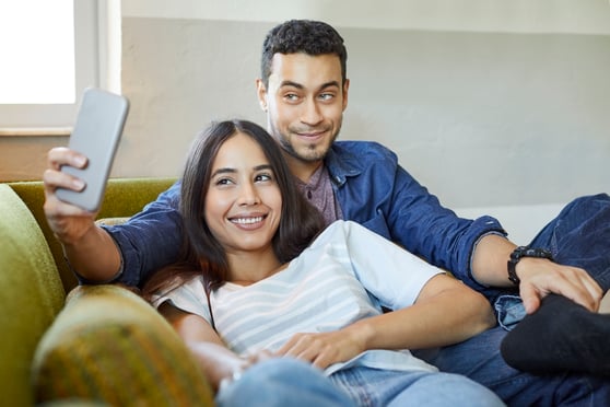 young couple on couch in south florida apartment 2